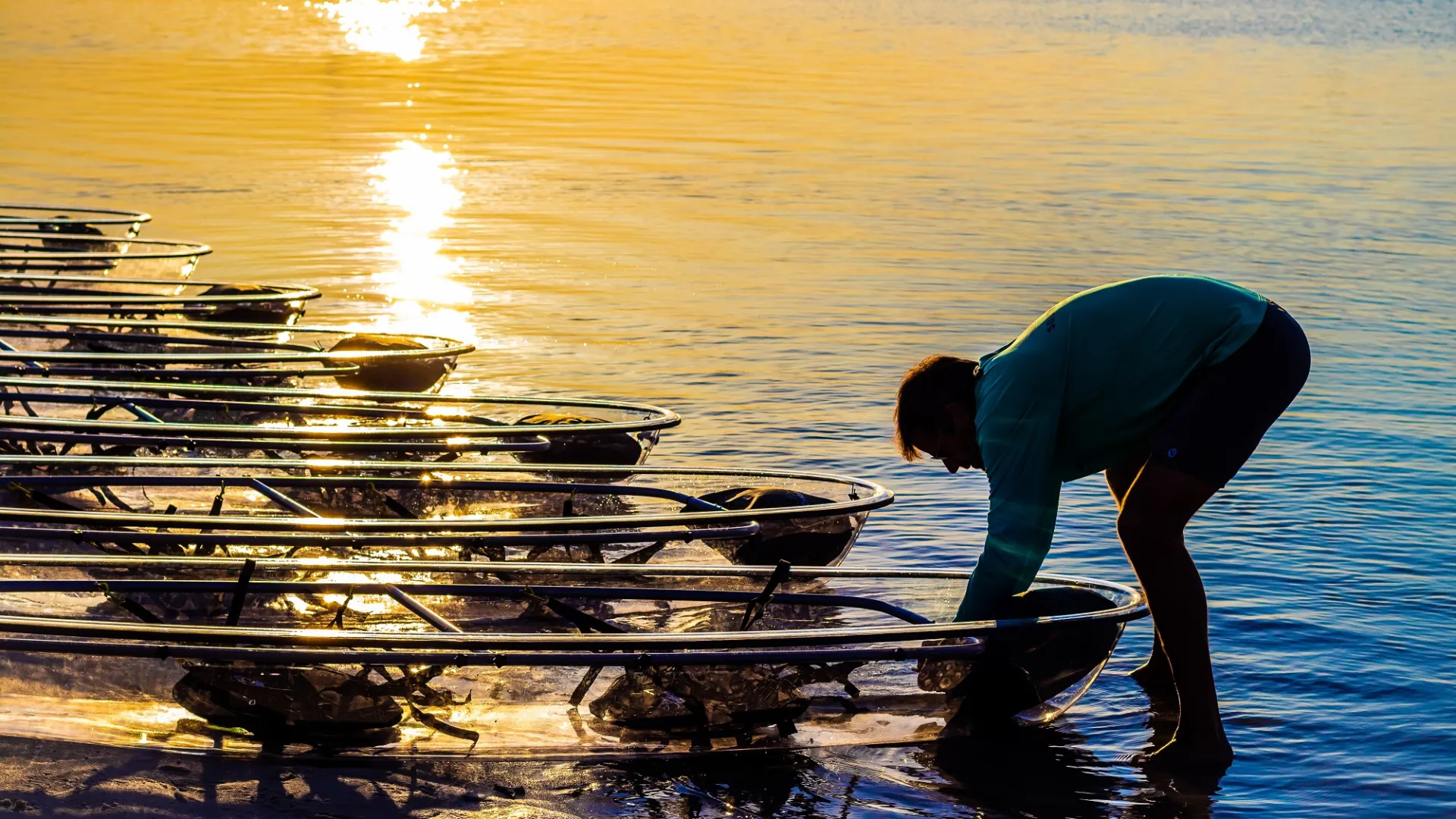 a man standing next to a body of water