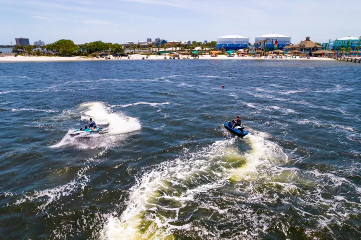a man riding a wave on top of a body of water